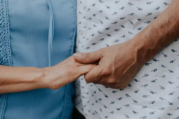 Older adults holding hands